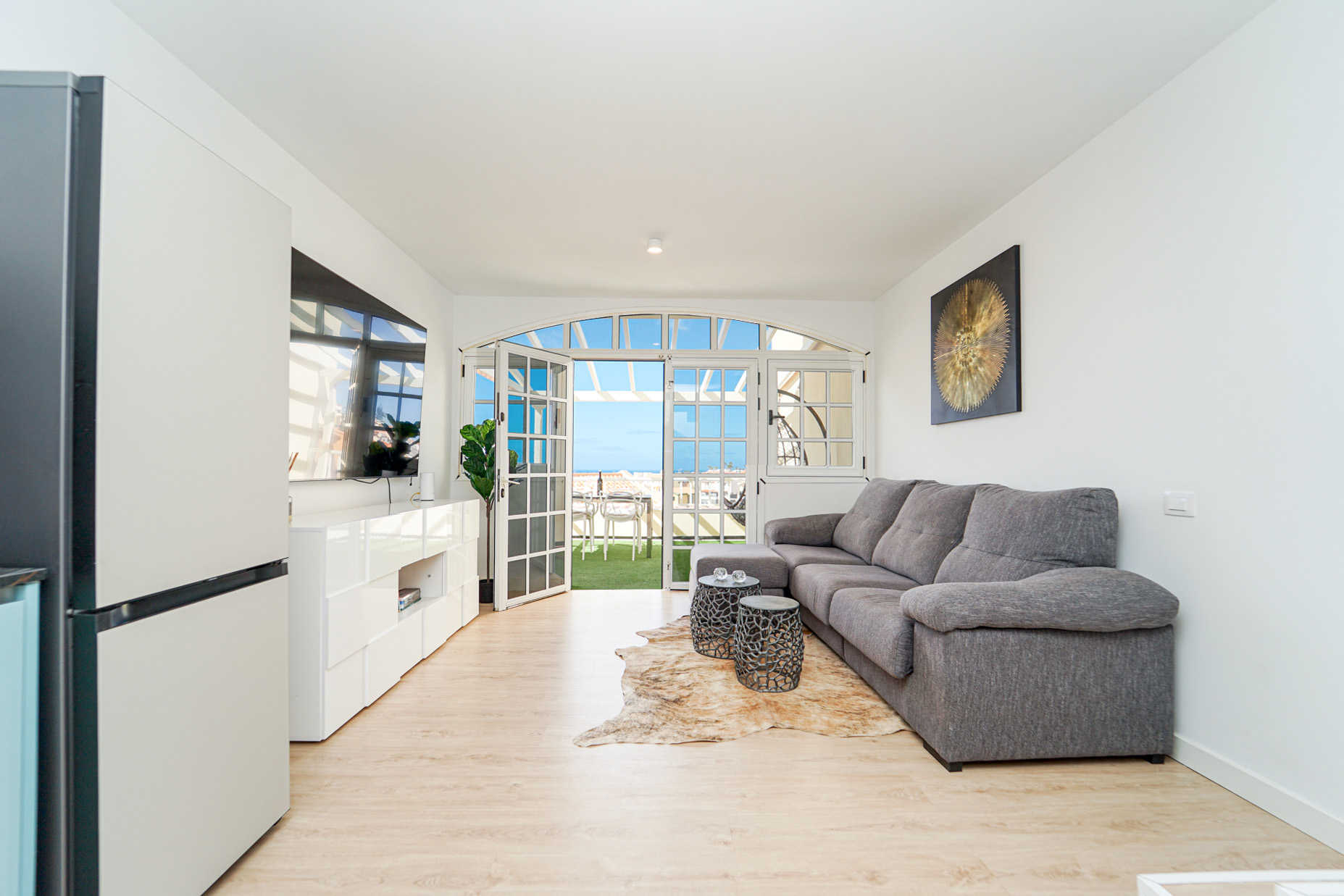 Coastal duplex living room with arched French doors and stunning ocean views