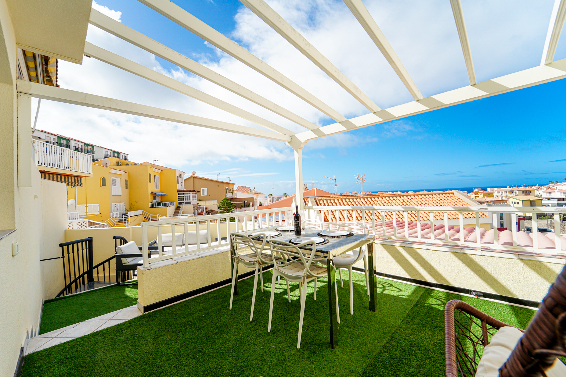 Coastal duplex covered terrace with pergola and Mediterranean views