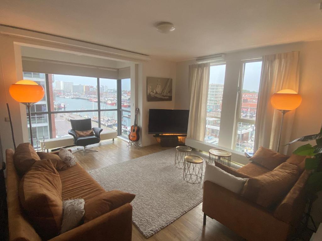 Cozy living room with harbor views, orange pendant lighting and contemporary furnishings