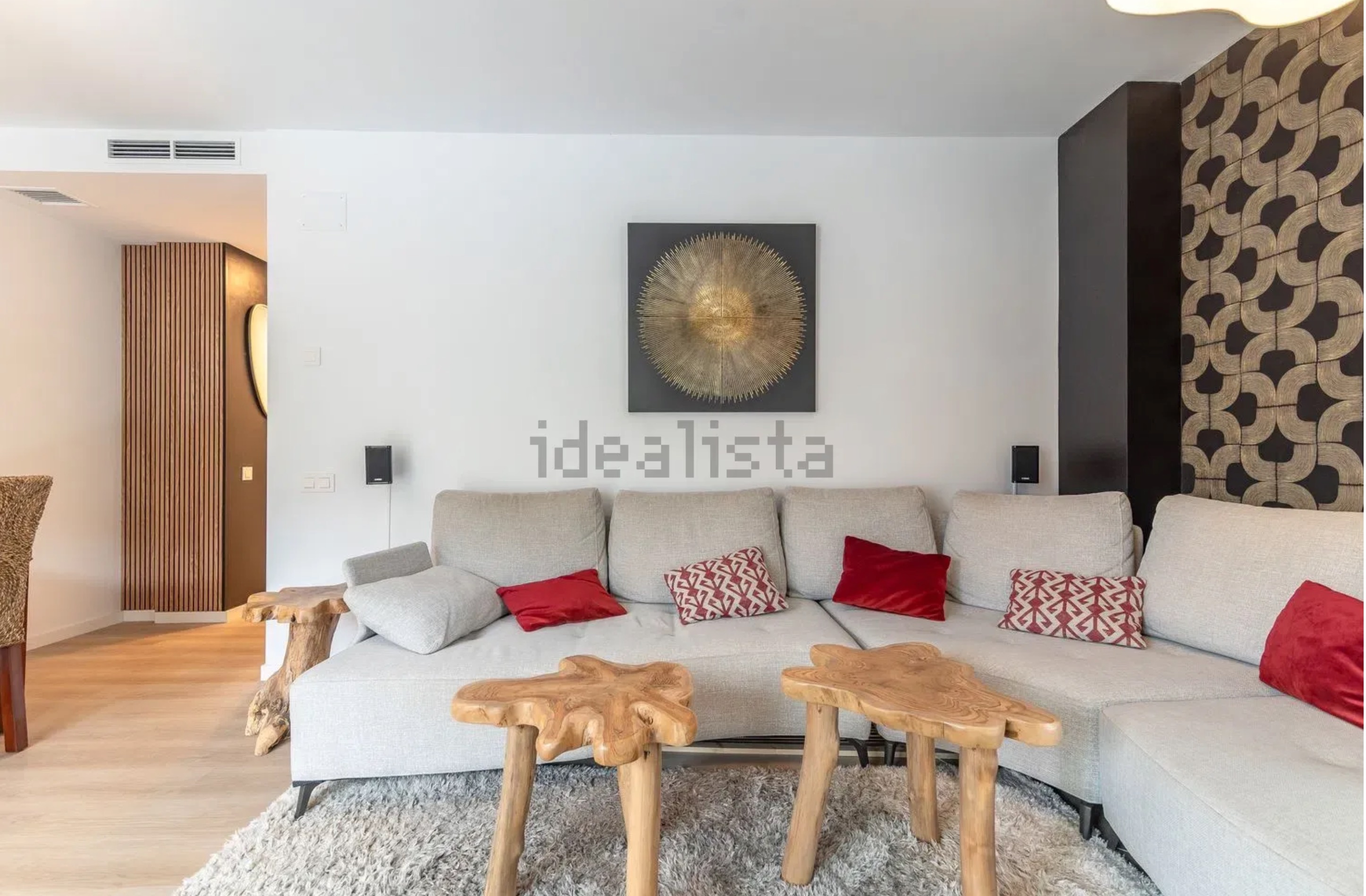 Modern living room with geometric accent wall and natural wood elements